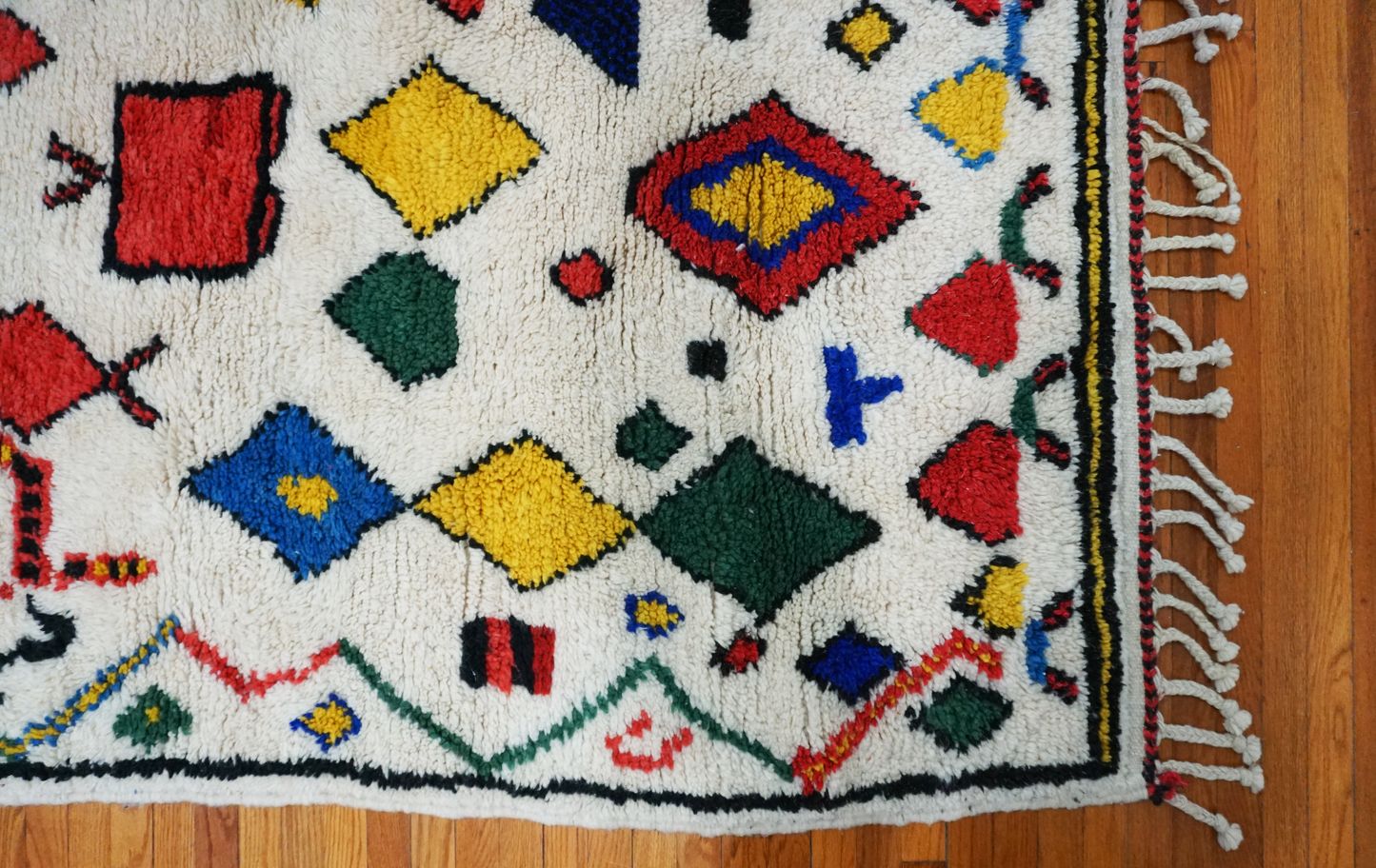 Colorful geometric-patterned rug on a wooden floor