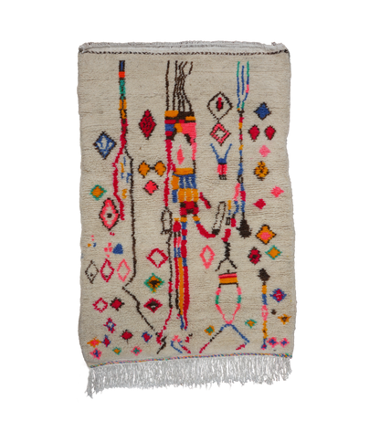Medium hand knotted azilal rug with bright colorful patterns and fringes on a neutral background
