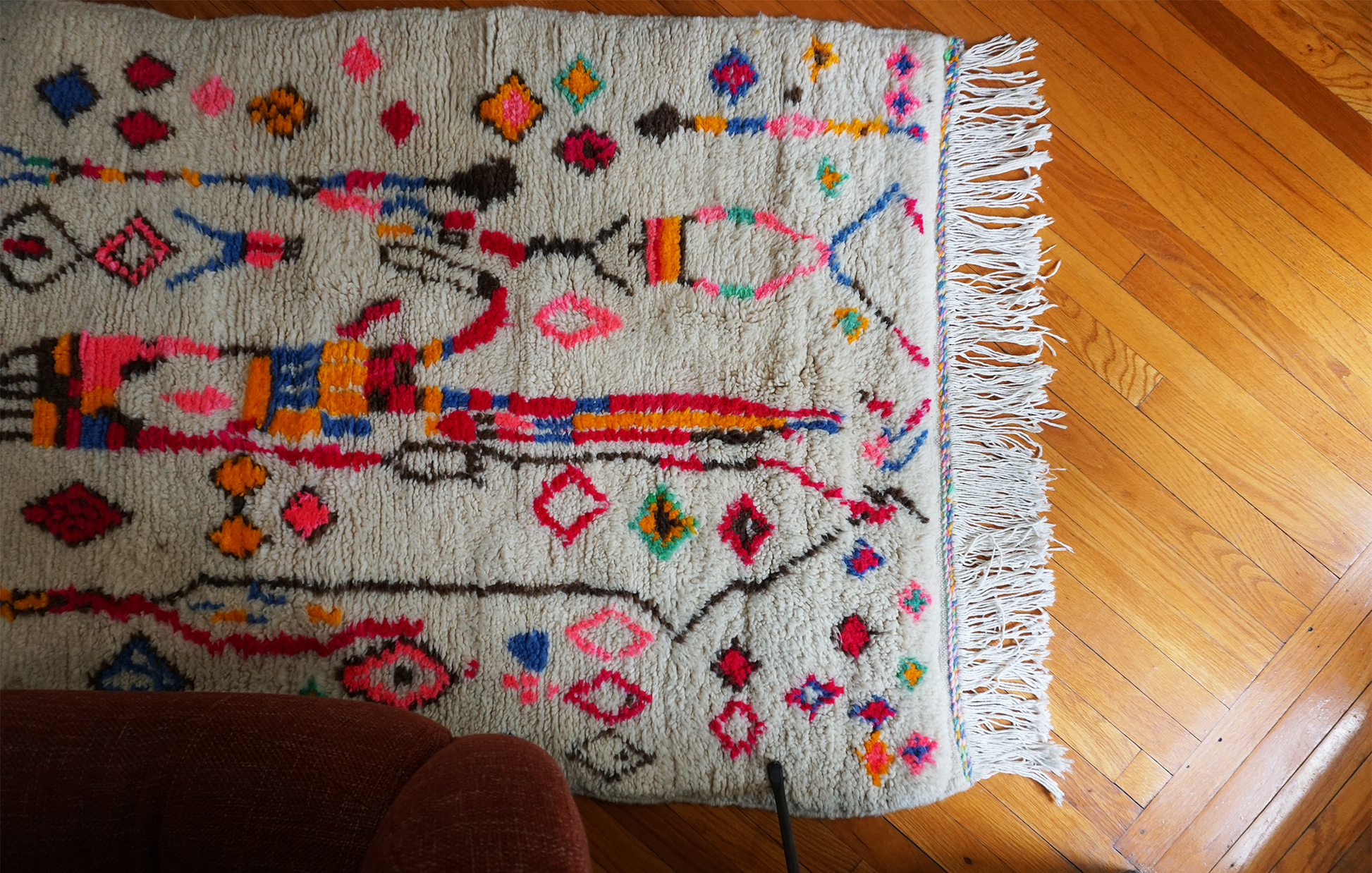 Colorful patterned rug on a wooden floor