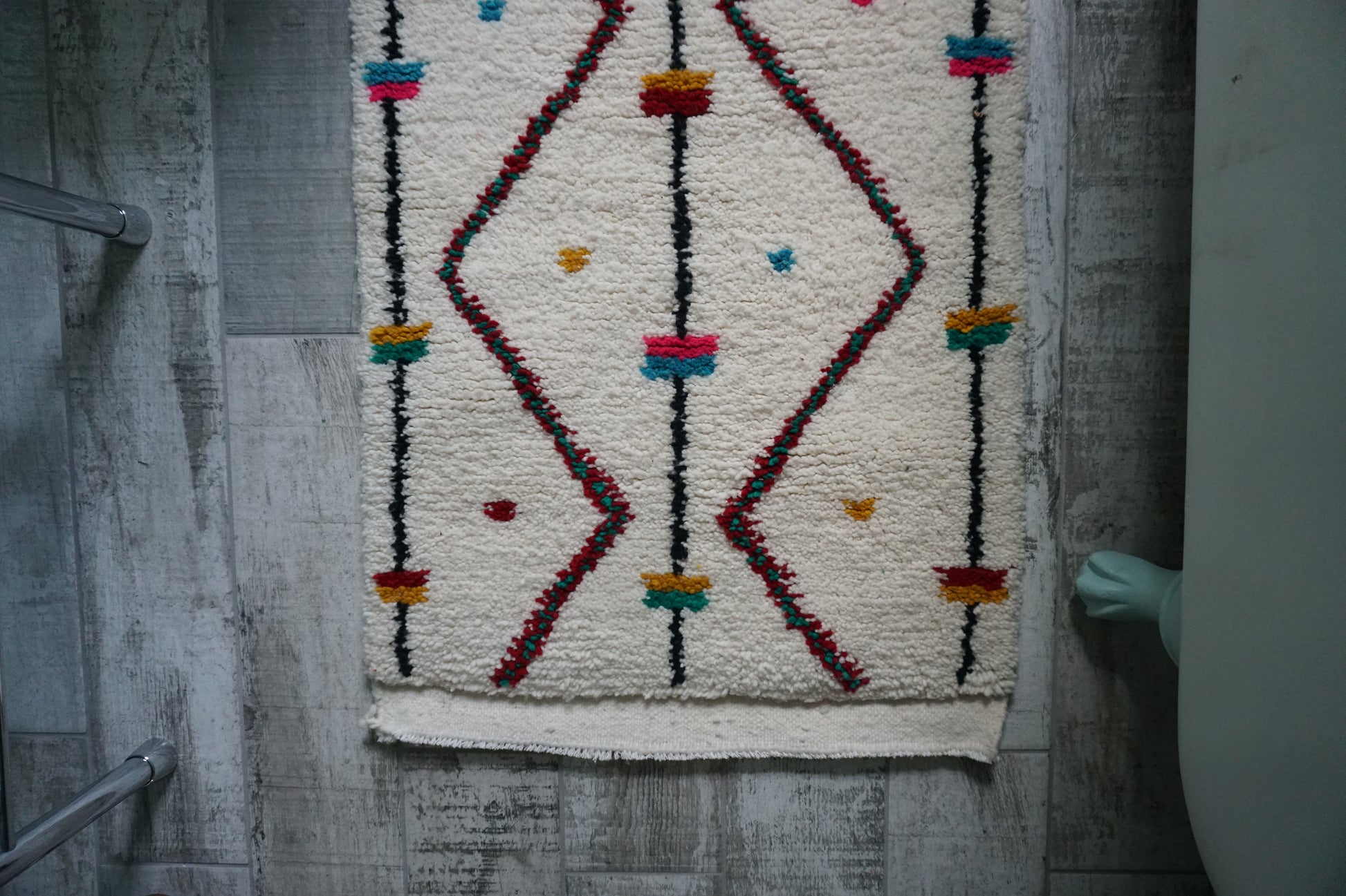 Decorative rug with geometric pattern on a wooden floor